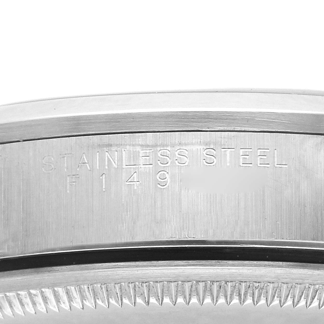 The image shows a detailed view of the side of the stainless steel case of a Rolex Air-King 14000 Men
s Stainless Steel Silver Dial, highlighting the engravings.
