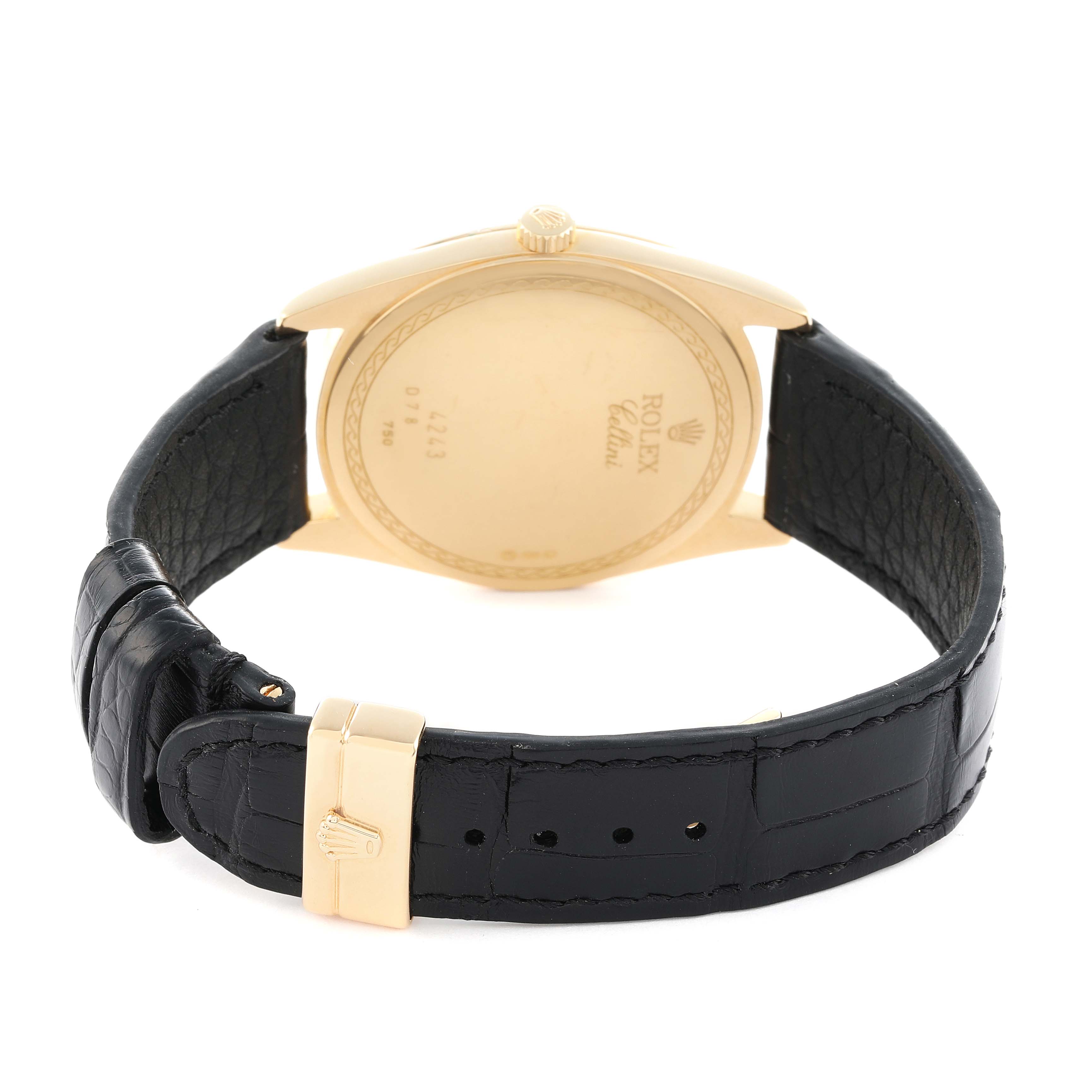 The image shows the back of a Rolex Cellini 4243 Men
s Yellow Gold White Dial watch, highlighting the gold case and leather strap with a gold clasp.