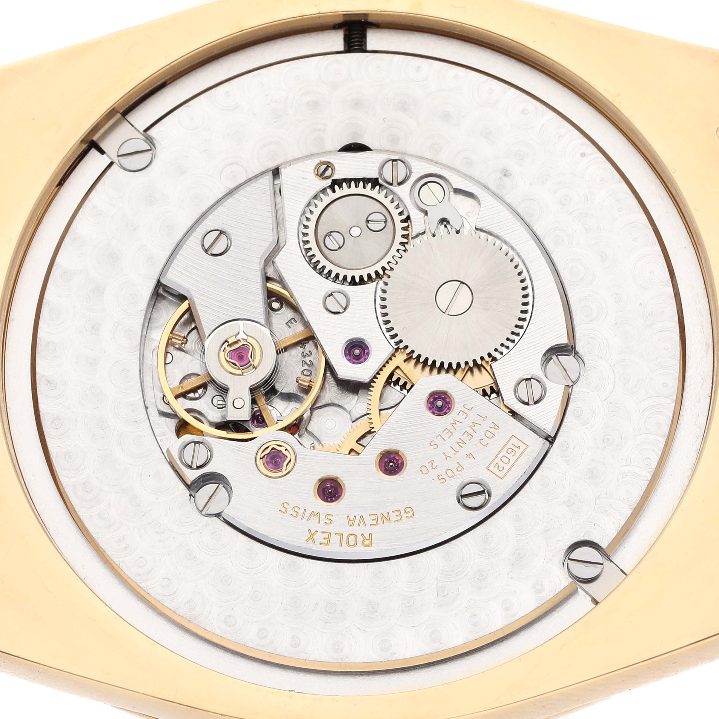 The image shows the internal movement of a Rolex Cellini 4243 Men
s Yellow Gold White Dial, focusing on gears and jewels from a top-down angle.