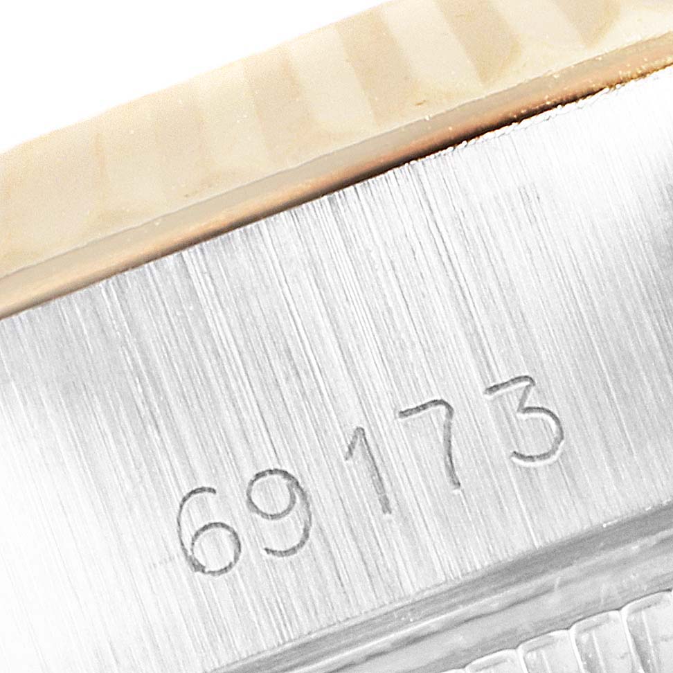 This close-up image shows the serial number and fluted bezel of the Rolex Datejust 69173 Women's Steel and Gold (two tone) Champagne Dial 69173 Women's Steel and Gold (two tone) Champagne Dial watch.