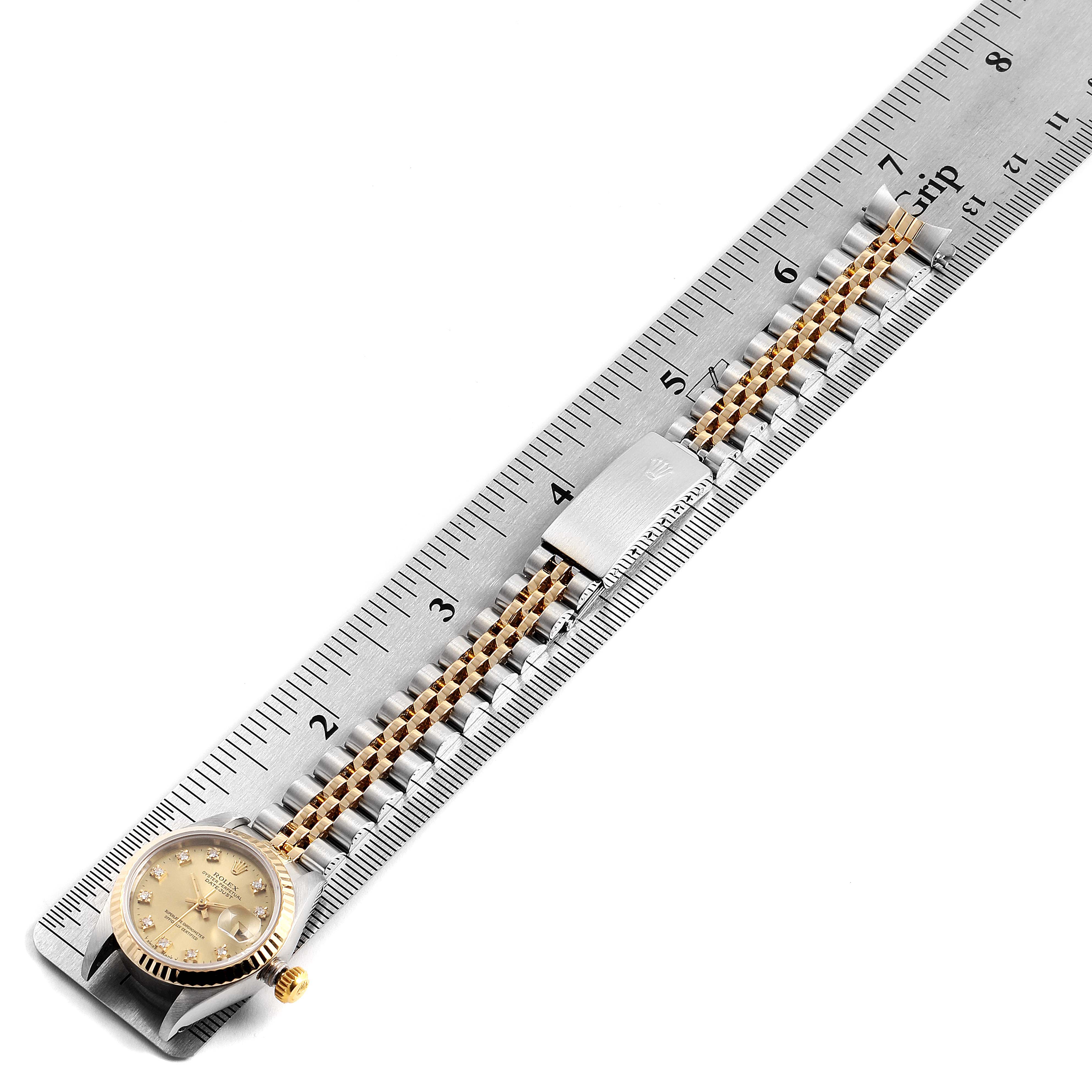 The image shows a Rolex Datejust 69173 Women's Steel and Gold (two tone) Champagne Dial 69173 Women's Steel and Gold (two tone) Champagne Dial watch lying flat with its face and bracelet measured against a ruler.