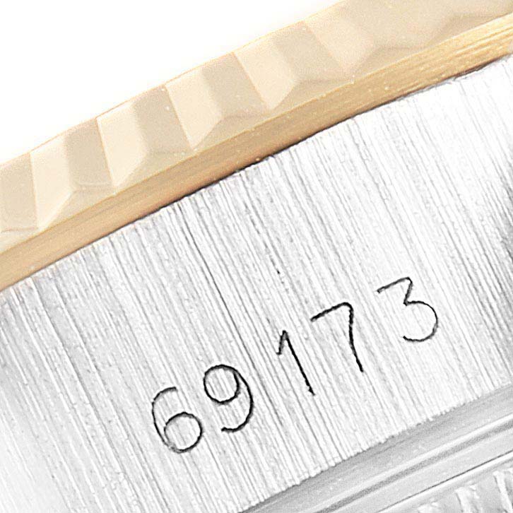 The image shows a close-up of the serial number and fluted bezel of a Rolex Datejust 69173 Women's Steel and Gold (two tone) Champagne Dial 69173 Women's Steel and Gold (two tone) Champagne Dial watch.