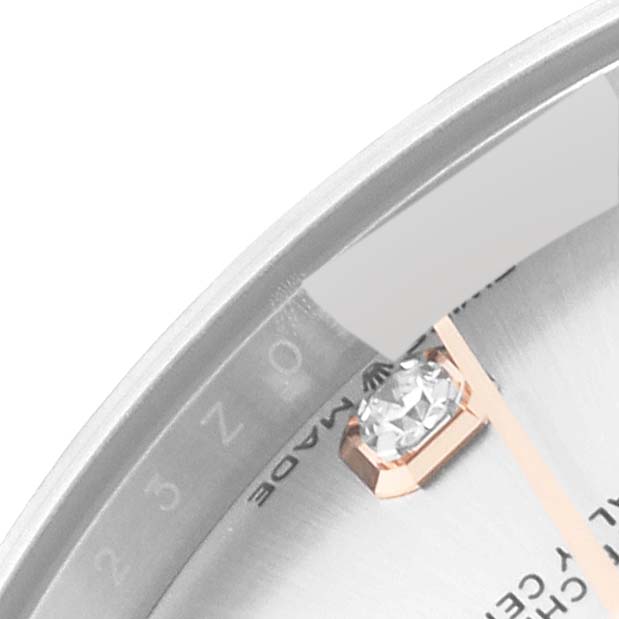 The image shows a close-up of the dial and bezel of a Rolex Mid-Size 278341 Women
s Steel and Gold (two tone) Silver Dial 278341 Women
s Steel and Gold (two tone) Silver Dial watch, highlighting a diamond hour marker.