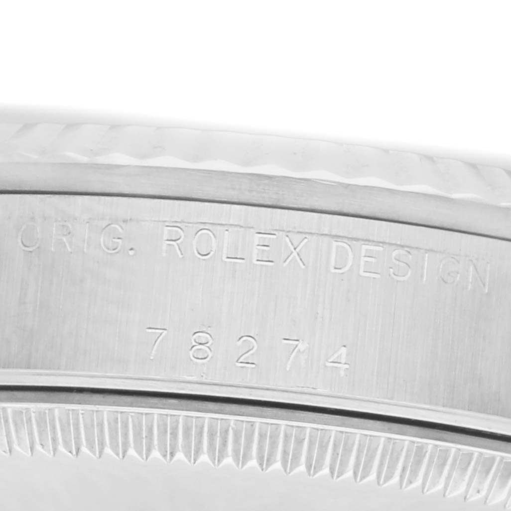 The image shows a close-up of the engraved case edge of a Rolex Datejust 178274 Women
s Stainless Steel Silver Dial, highlighting "ORIG. ROLEX DESIGN" and the model number.
