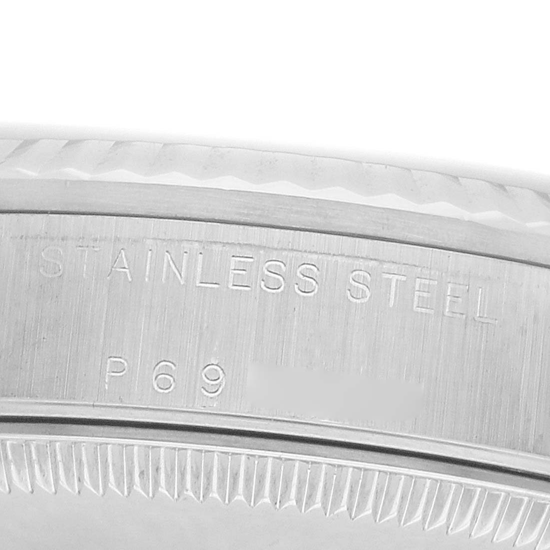 The image shows a close-up of the case back edge of a Rolex Datejust 178274 Women
s Stainless Steel Silver Dial, highlighting the "STAINLESS STEEL" engraving.