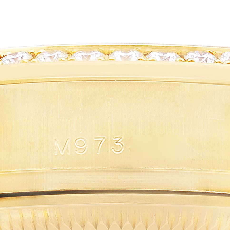 The image shows a close-up side view of the bezel with diamond detailing and engraved numbers on a Rolex Datejust 179138 Women
s Yellow Gold Black Dial.