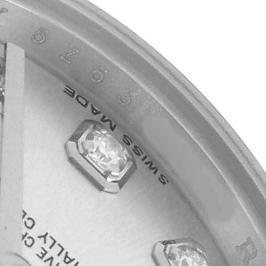 The image shows a close-up of the dial on a Rolex Datejust 179174 Women
s Steel and Gold (two tone) Silver Dial, highlighting diamond markers and the "Swiss Made" inscription.