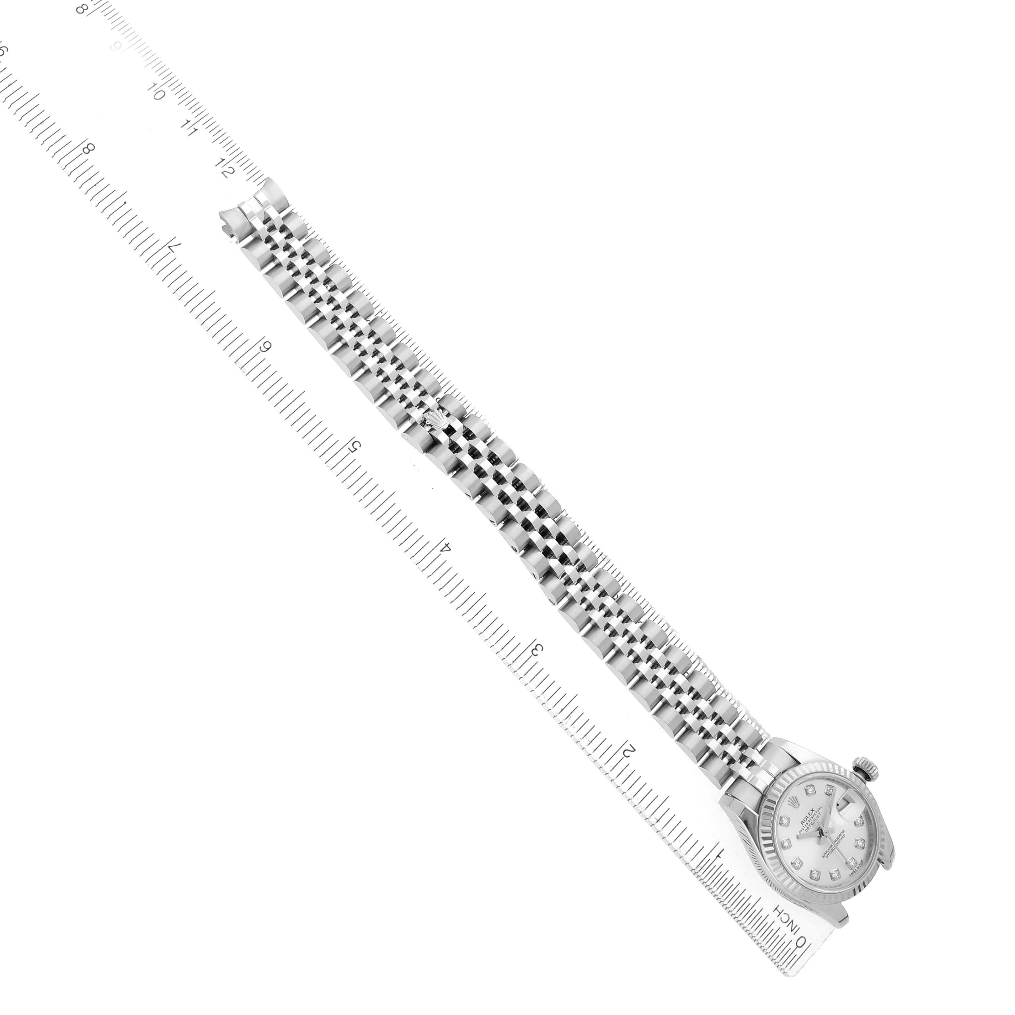 The Rolex Datejust 179174 Women
s Steel and Gold (two tone) Silver Dial watch is shown at an angle with the face, bracelet, and part of the clasp visible, alongside a ruler.