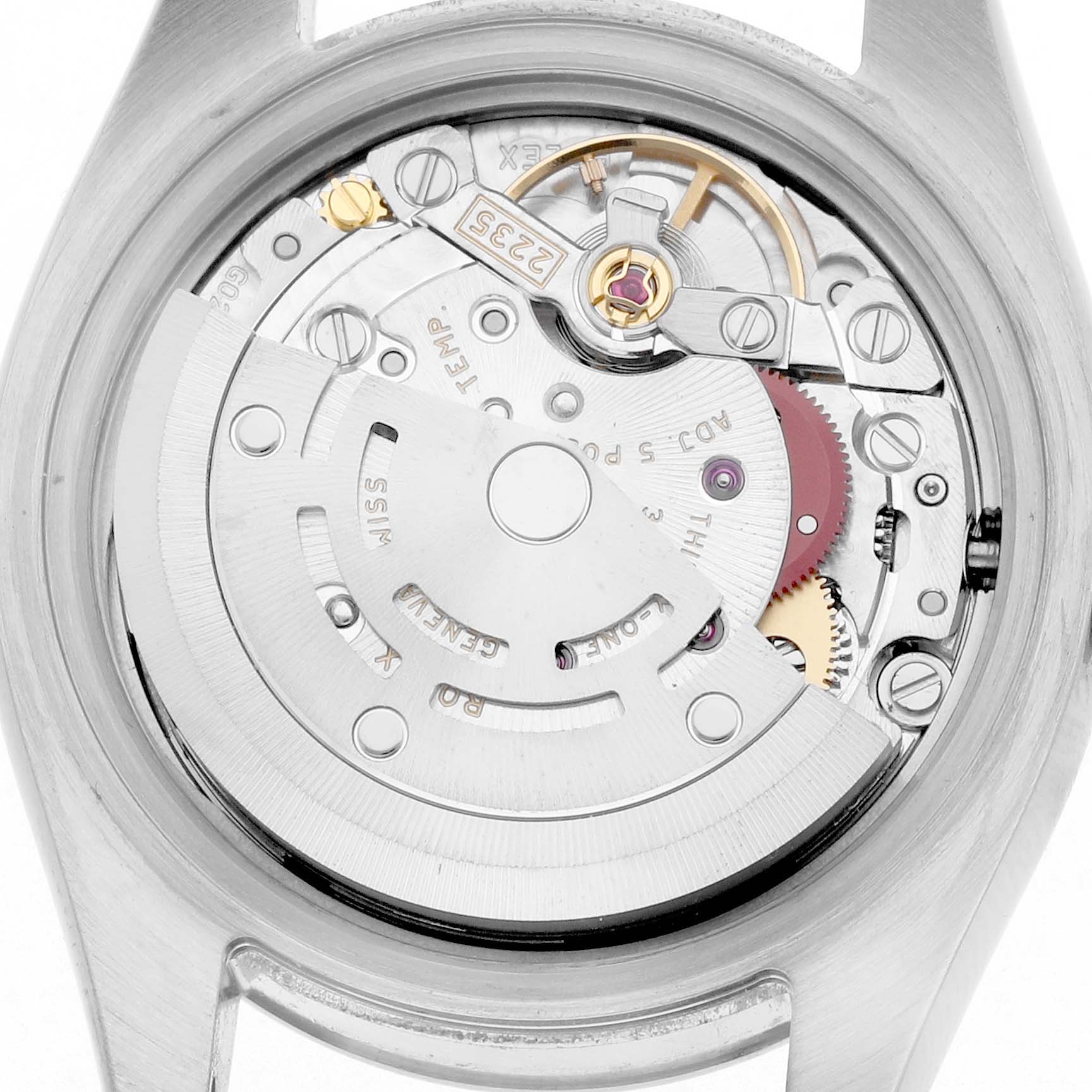 The image shows the movement of a Rolex Datejust 179174 Women
s Steel and Gold (two tone) Silver Dial, viewed from the case back, highlighting the automatic winding mechanism.