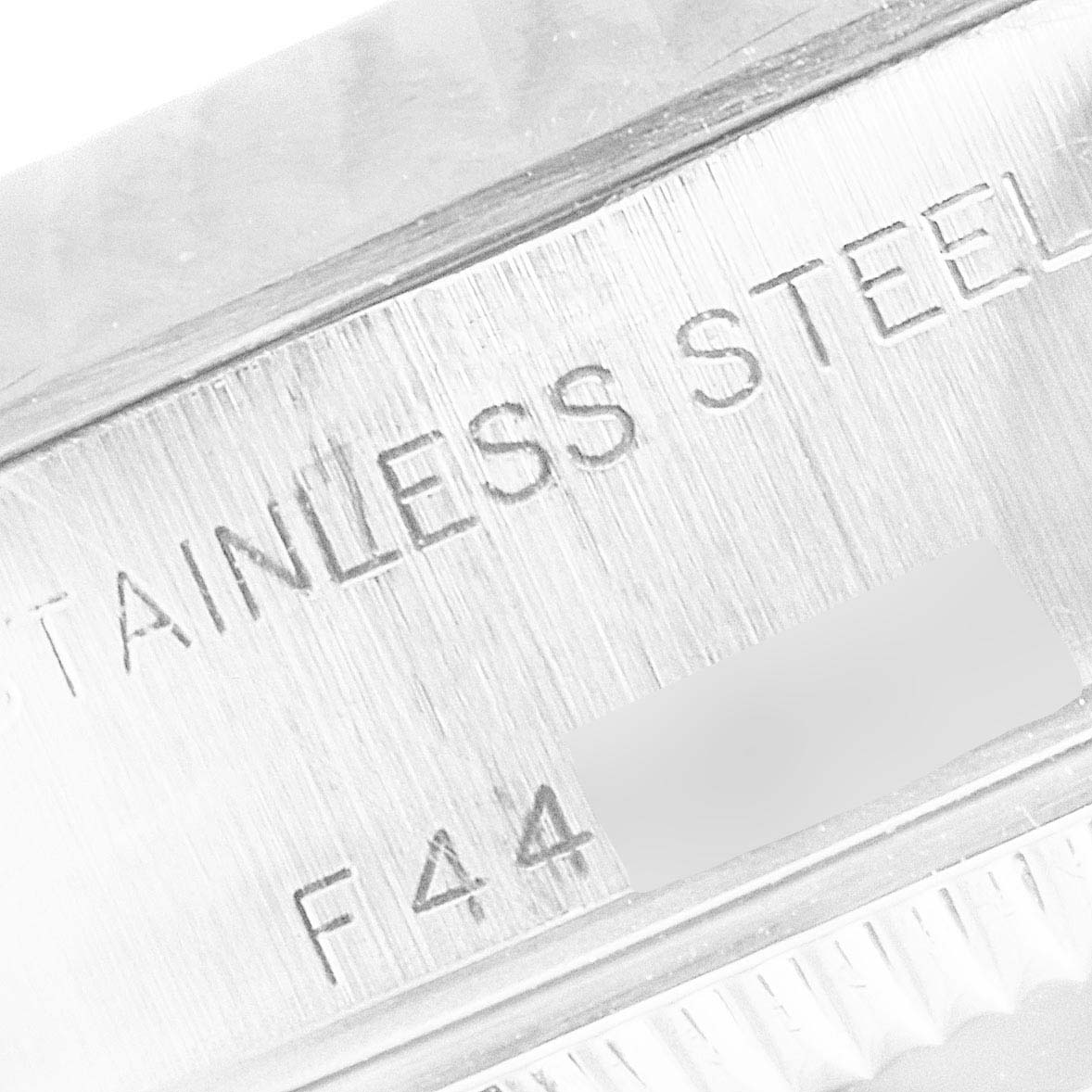 This image shows a close-up of the side engravings on a Rolex Datejust 79174 Women's Stainless Steel Mother of Pearl Dial 79174 Women's Stainless Steel Mother of Pearl Dial watch, highlighting the "STAINLESS STEEL" text.