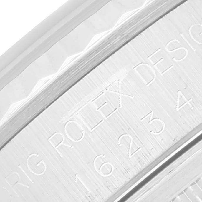 This is a close-up shot of the side engraving on a Rolex Datejust 16234 Men's Stainless Steel Silver Dial 16234 Men's Stainless Steel Silver Dial watch.