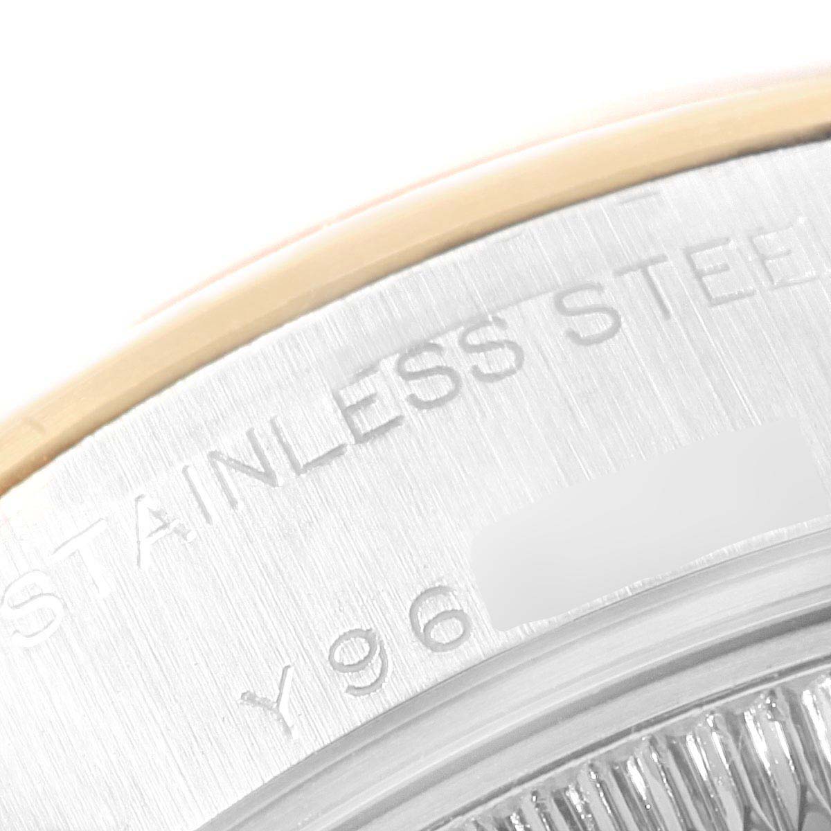 This image shows a close-up of the case back, revealing the outer rim and engraved text on a Rolex Datejust 79163 Women's Steel and Gold (two tone) Champagne Dial 79163 Women's Steel and Gold (two tone) Champagne Dial watch.