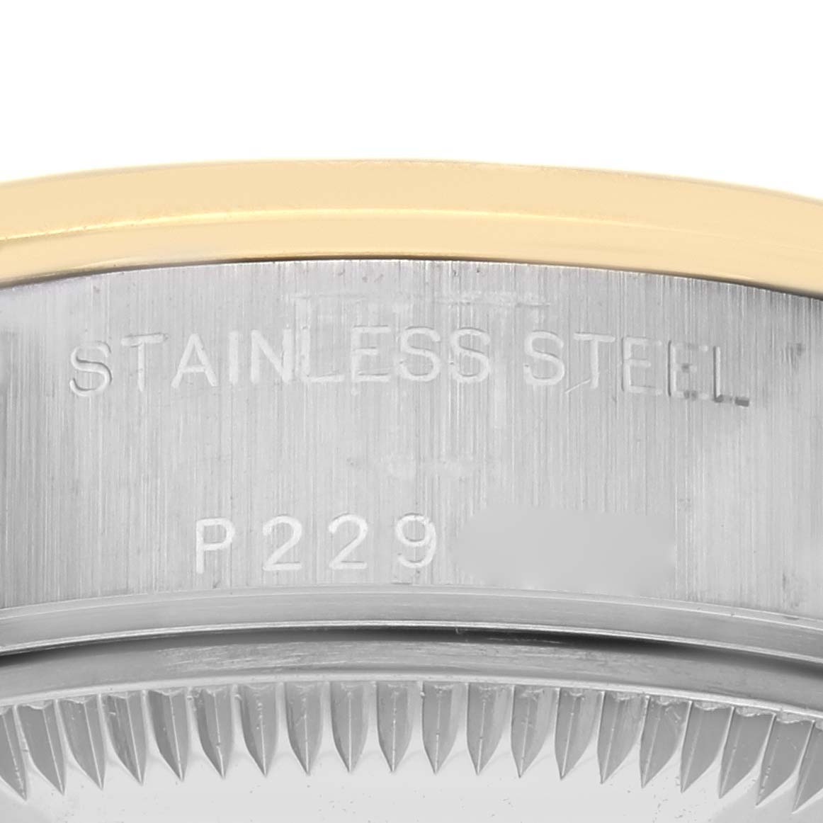 Close-up of the side of a Rolex Datejust 79163 Women
s Steel and Gold (two tone) Champagne Dial 79163 Women
s Steel and Gold (two tone) Champagne Dial watch, showing stainless steel casing and part of the bezel.