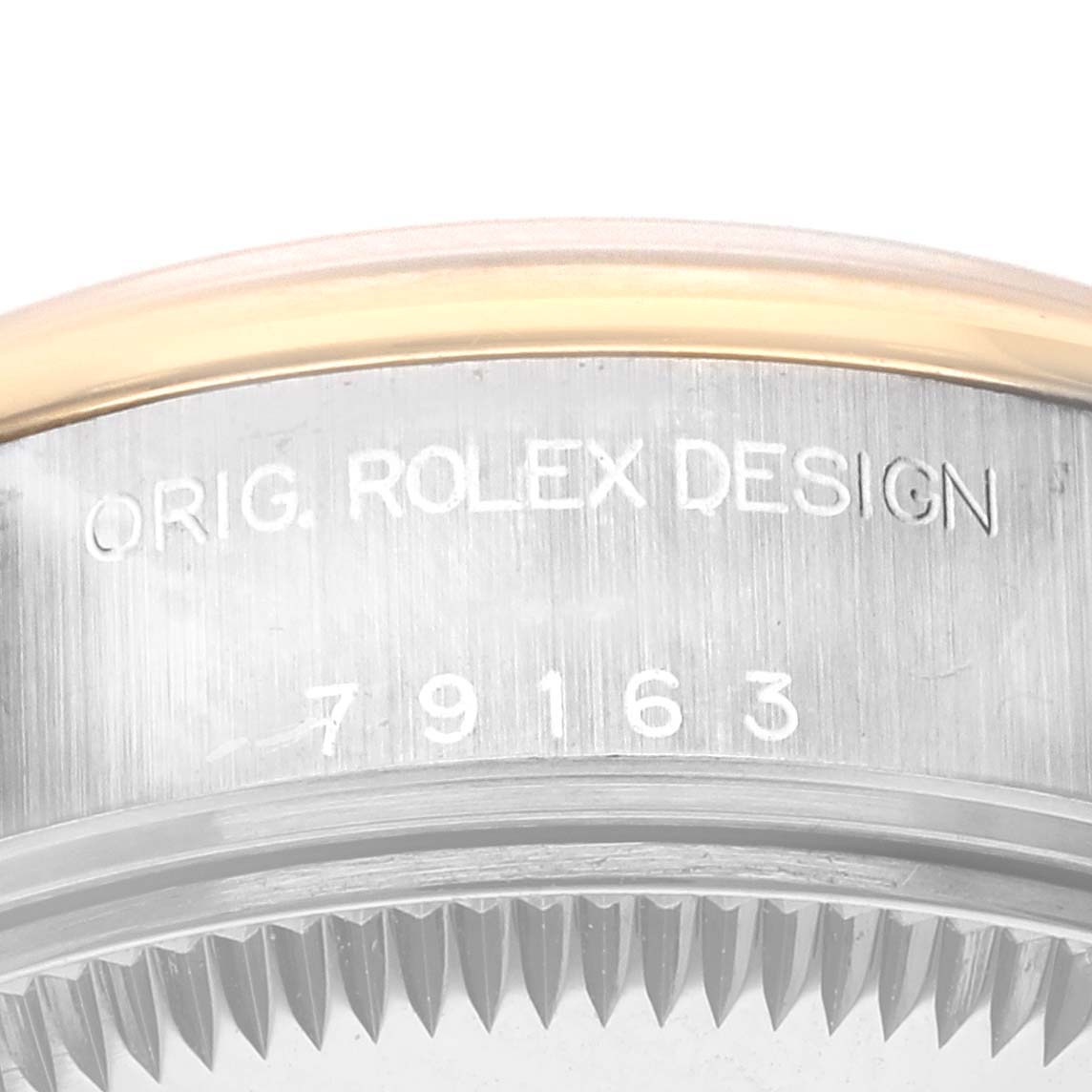 The image shows a close-up angle of the case edge of a Rolex Datejust 79163 Women
s Steel and Gold (two tone) Champagne Dial 79163 Women
s Steel and Gold (two tone) Champagne Dial watch, displaying "ORIG. ROLEX DESIGN 79163."