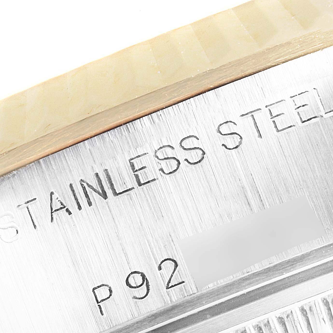 This image shows a close-up view of the stainless steel case and engraved text of a Rolex Datejust 79173 Women's Steel and Gold (two tone) Champagne Dial 79173 Women's Steel and Gold (two tone) Champagne Dial watch.