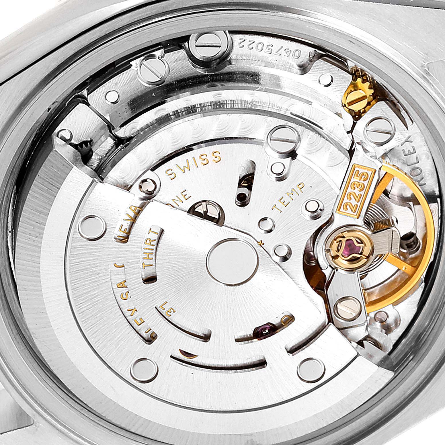 This is a close-up view of the movement inside a Rolex Datejust 79173 Women's Steel and Gold (two tone) Champagne Dial 79173 Women's Steel and Gold (two tone) Champagne Dial watch, showing intricate mechanical parts and engravings.