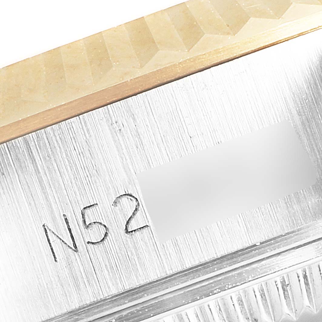 This image shows the case side of a Rolex Datejust 69173 Women's Steel and Gold (two tone) Champagne Dial 69173 Women's Steel and Gold (two tone) Champagne Dial watch displaying part of its serial number and the edge of its bezel.