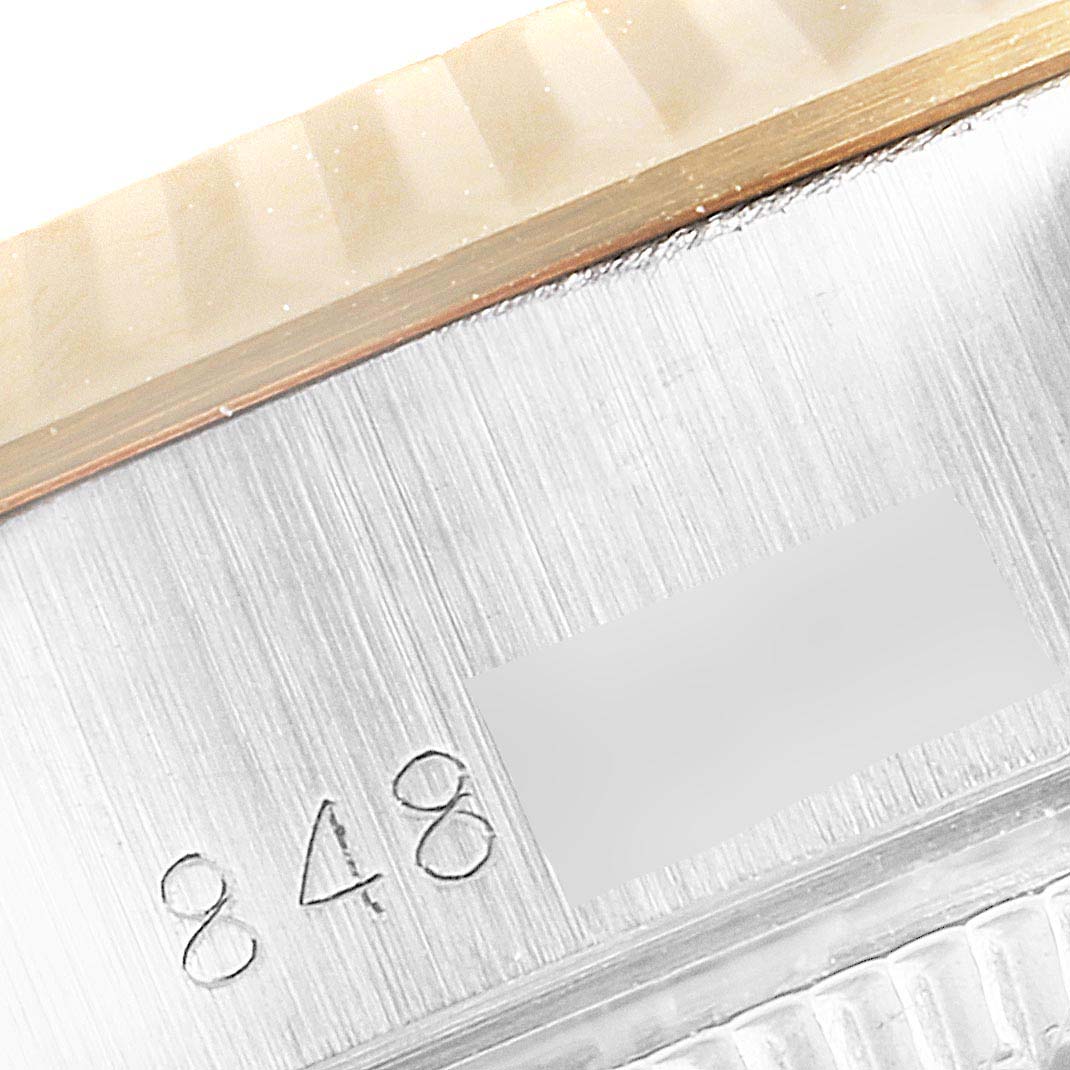 This image shows a close-up of the case side and serial number of a Rolex Datejust 69173 Women's Steel and Gold (two tone) Champagne Dial 69173 Women's Steel and Gold (two tone) Champagne Dial watch.