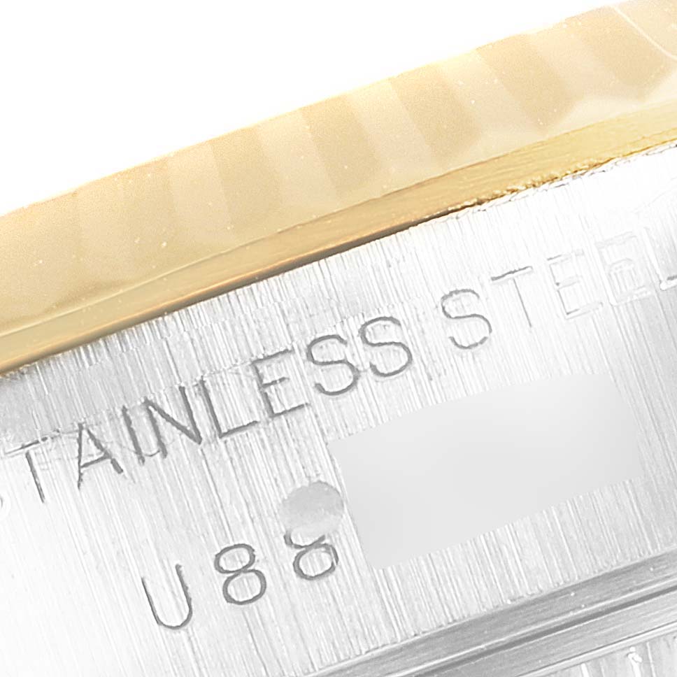 This close-up image shows the engraved "STAINLESS STEEL" text on the side of the case of a Rolex Datejust 69173 Women's Steel and Gold (two tone) Silver Dial 69173 Women's Steel and Gold (two tone) Silver Dial watch.