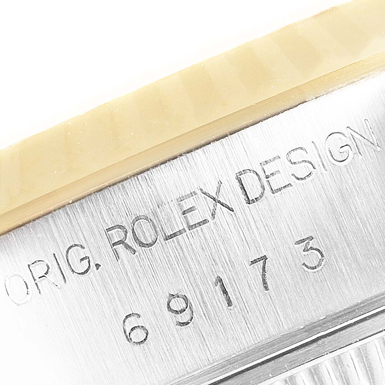 This image shows a close-up view of the marking and fluted bezel on a Rolex Datejust 69173 Women's Steel and Gold (two tone) Silver Dial 69173 Women's Steel and Gold (two tone) Silver Dial watch.