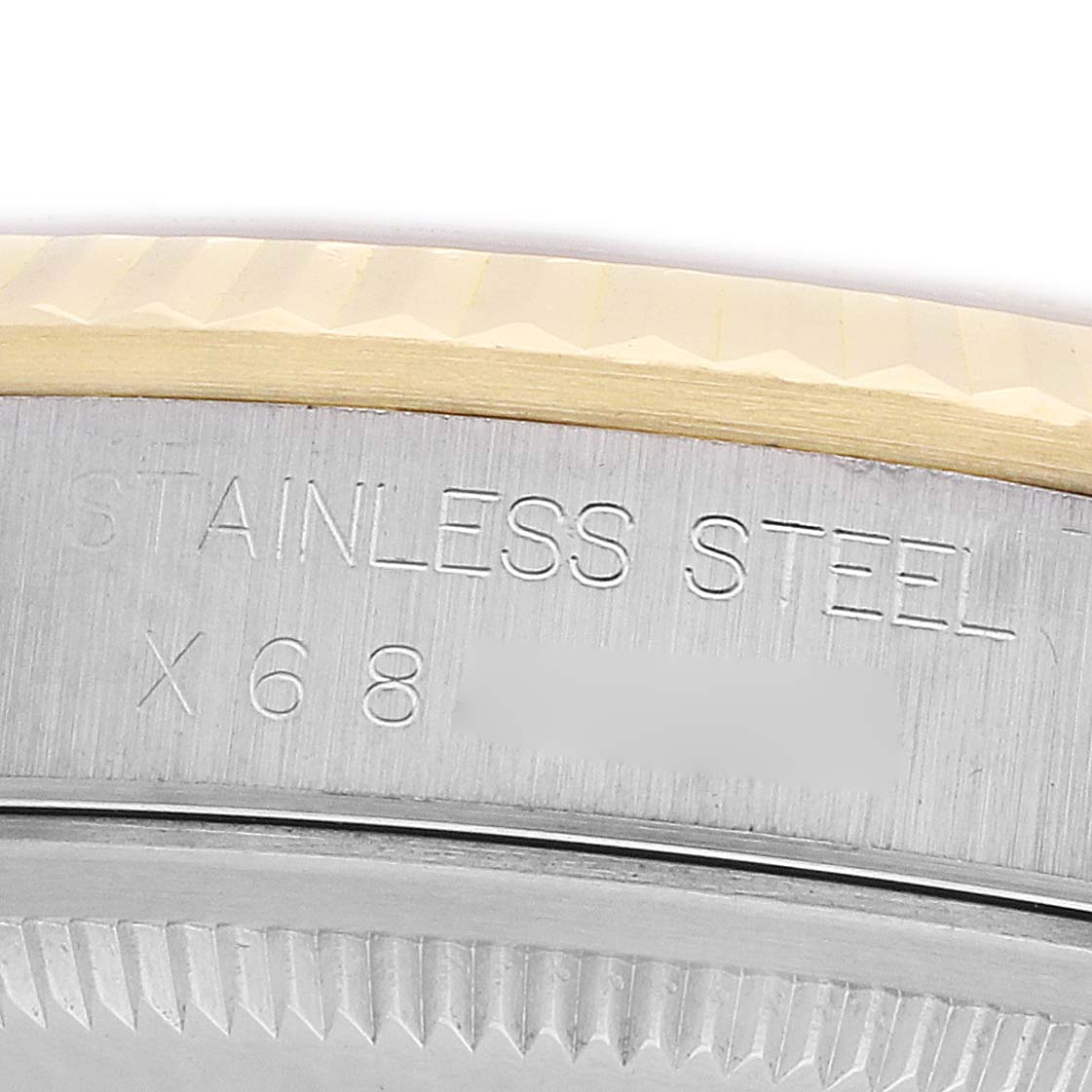 The image shows an angled close-up of the case back of a Rolex Datejust 16233 Men
s Steel and Gold (two tone) Blue Dial, highlighting the stainless steel engraving.
