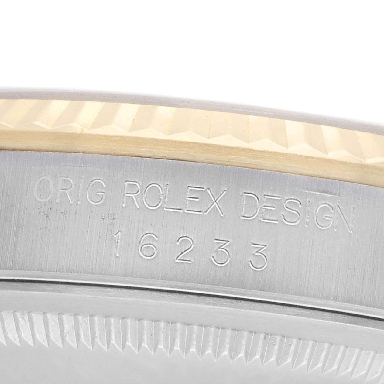 The image shows a close-up of the side of a Rolex Datejust 16233 Men
s Steel and Gold (two tone) Blue Dial, highlighting the engraved model number and fluted bezel.