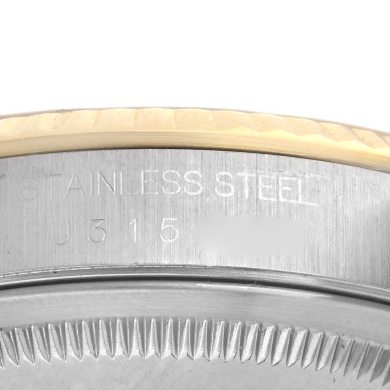 This close-up image of a Rolex Datejust 16233 Men's Steel and Gold (two tone) White Dial 16233 Men's Steel and Gold (two tone) White Dial watch shows the stainless steel engraving and part of the bezel.
