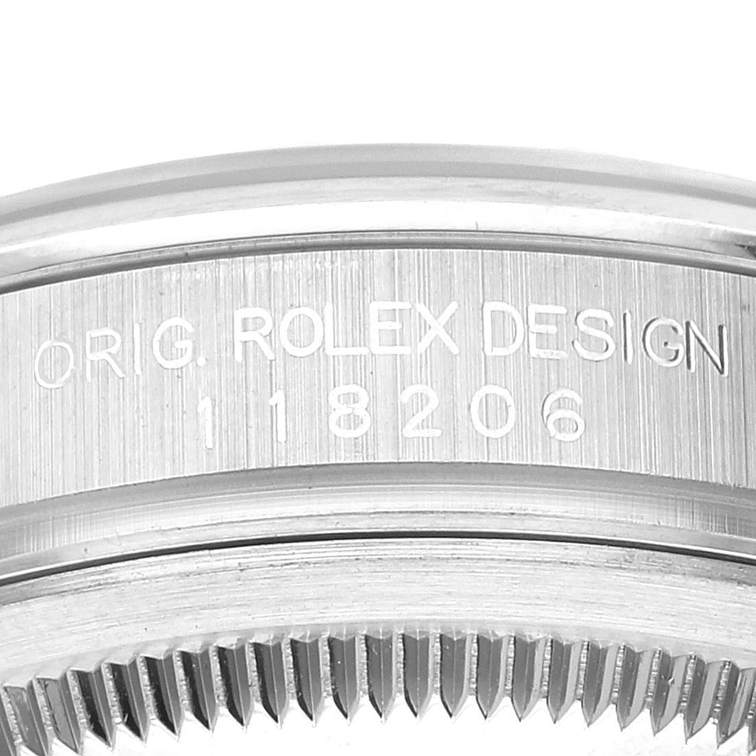 The image shows a close-up of the engraved case back and fluted bezel of a Rolex President 118206 Men's Platinum Silver Dial 118206 Men's Platinum Silver Dial model watch.