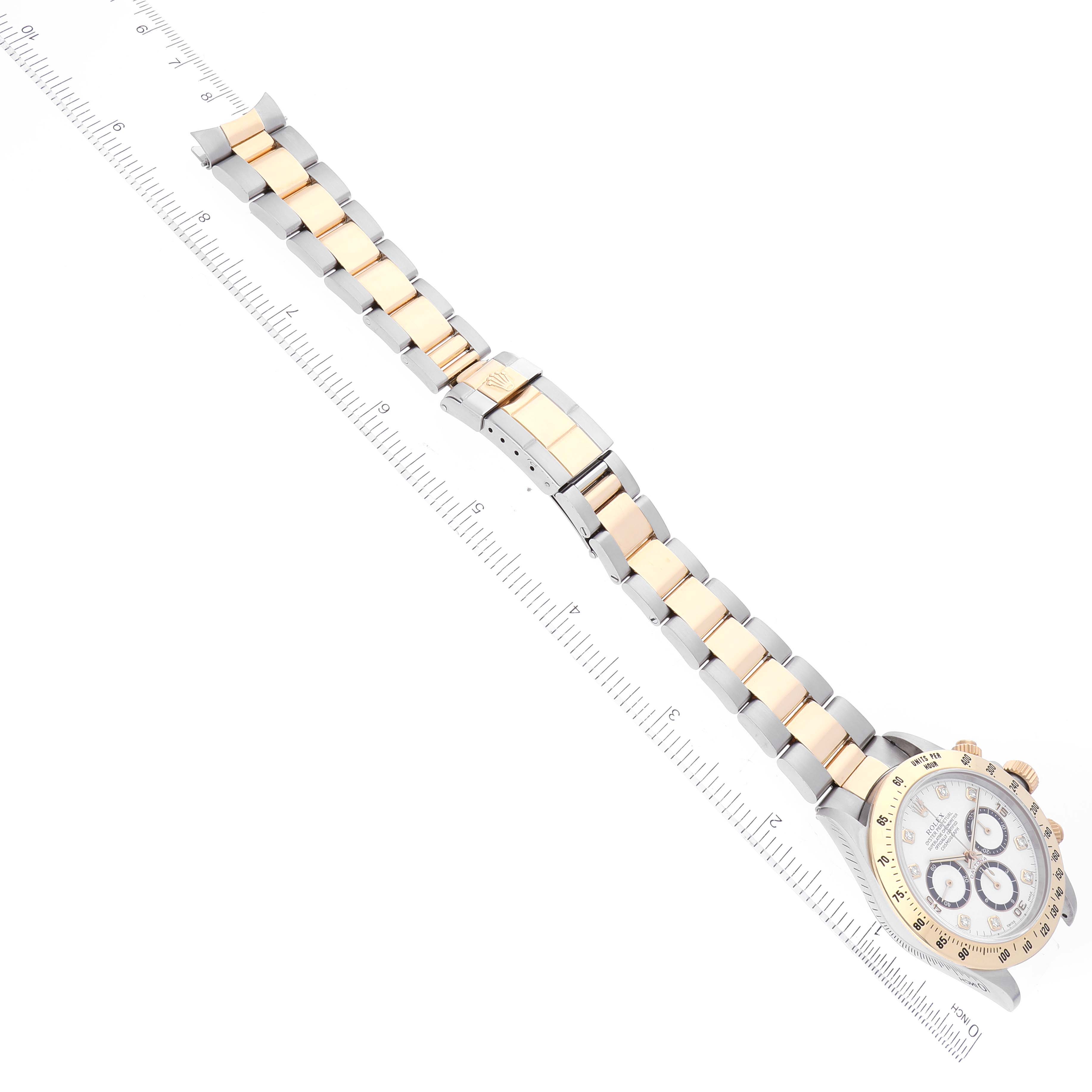 This image shows a Rolex Daytona 16523 Men's Steel and Gold (two tone) White Dial 16523 Men's Steel and Gold (two tone) White Dial watch laid flat with the dial, bracelet, and a ruler for scale.