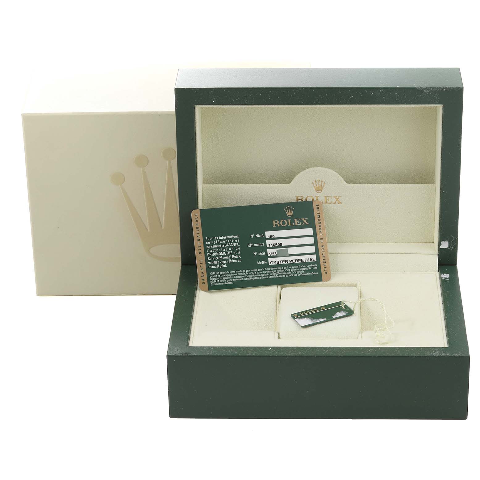 The image shows a Rolex watch box for the Daytona model with a warranty card and a tag inside.