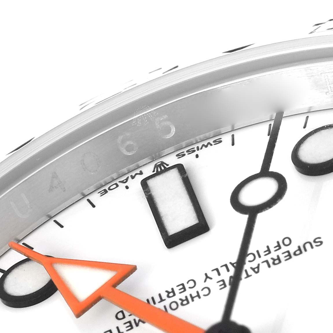 This close-up image of a Rolex Explorer 226570 Men's Stainless Steel White Dial 226570 Men's Stainless Steel White Dial model watch shows part of the face, including the hour markers, hands, and text.