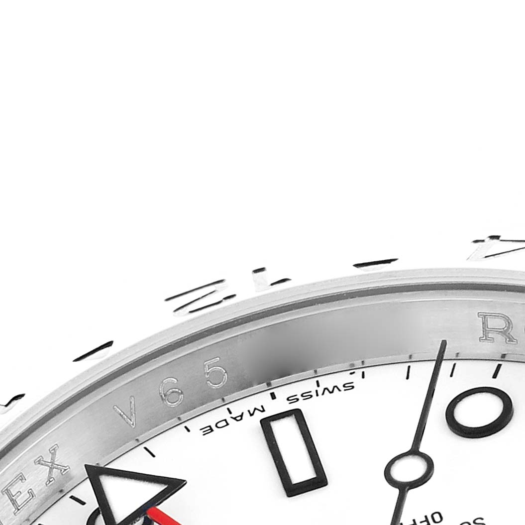 The image shows a close-up of the Rolex Explorer 16570 Men
s Stainless Steel White Dial
s dial and bezel, highlighting its markers and hands from an angled view.