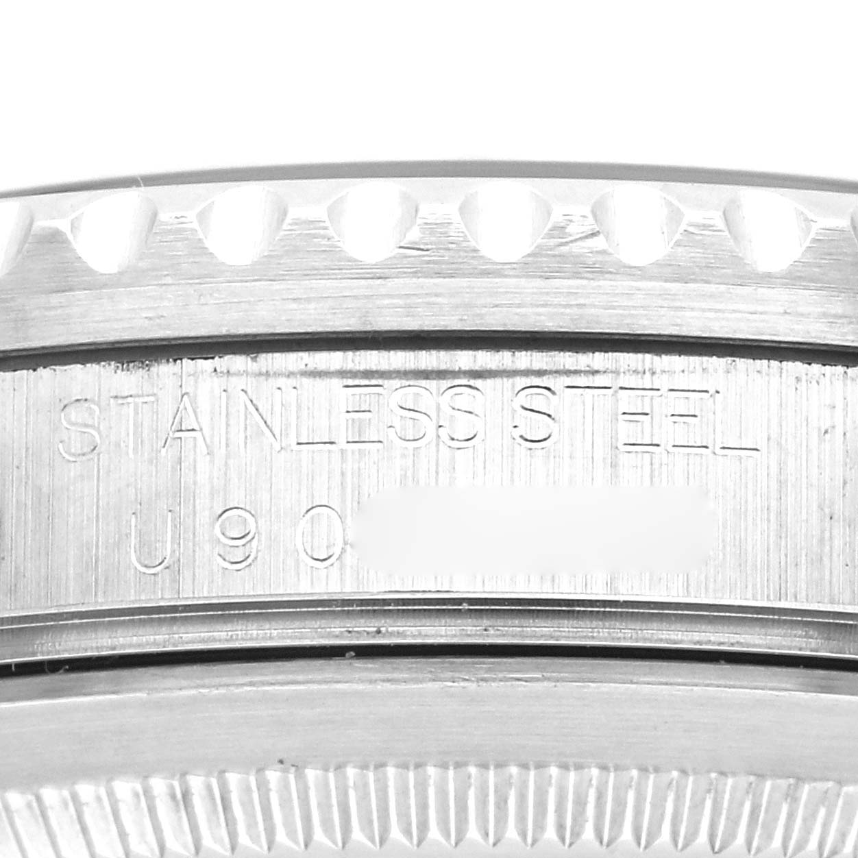 This image shows a close-up angle of the back case side of a Rolex GMT-Master 16700 Men's Stainless Steel Black Dial 16700 Men's Stainless Steel Black Dial watch, highlighting the stainless steel engraving.