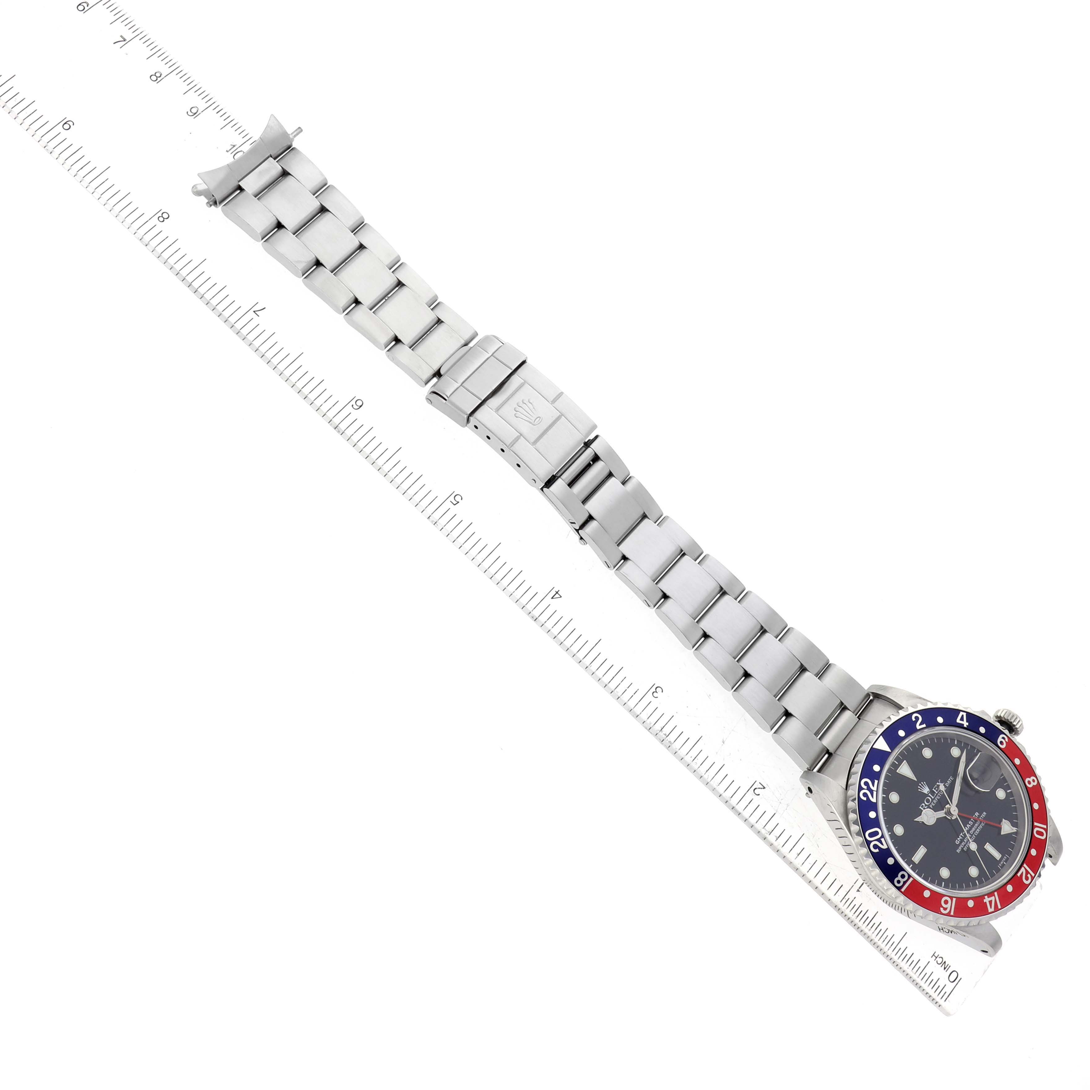 The image shows a top-down view of a Rolex GMT-Master 16700 Men's Stainless Steel Black Dial 16700 Men's Stainless Steel Black Dial watch, focusing on its metal bracelet and face with a 'Pepsi' bezel.