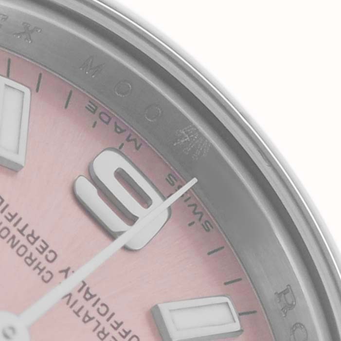 The image shows a close-up of the dial of a Rolex Oyster Perpetual 176200 Women
s Stainless Steel Pink Dial watch, focusing on the hour markers and hands.
