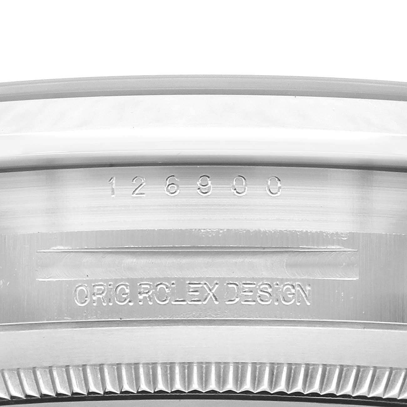 The image shows a close-up view of the engraved side of a Rolex Air-King 126900 Men
s Stainless Steel Black Dial watch, displaying its model number and design text.