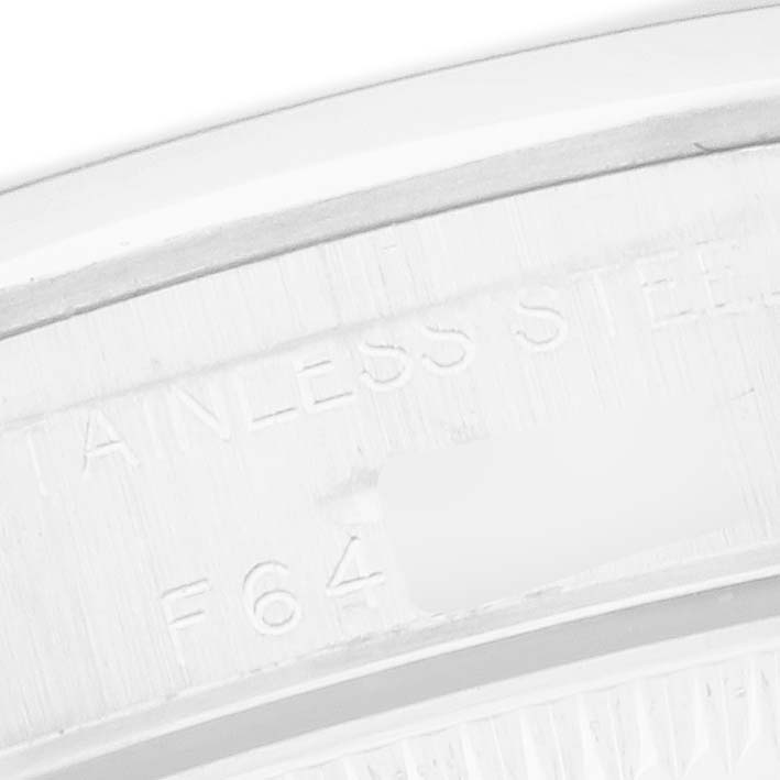The image shows a close-up of the case back edge of a Rolex Oyster Perpetual 76080 Women
s Stainless Steel Silver Dial, highlighting the engraved text.