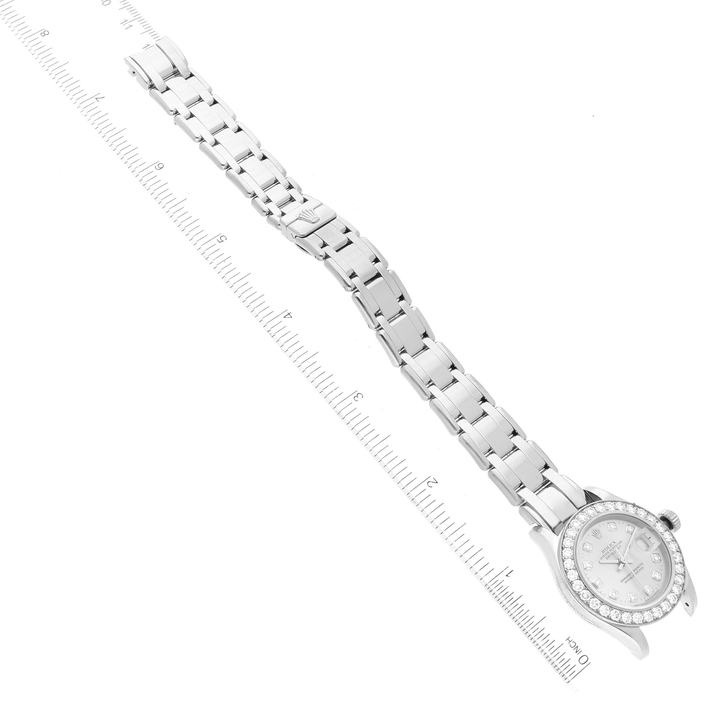 The Rolex Pearlmaster 80299 Women's White Gold Silver Dial watch is shown from a top-down angle, displaying the full bracelet and bejeweled face.