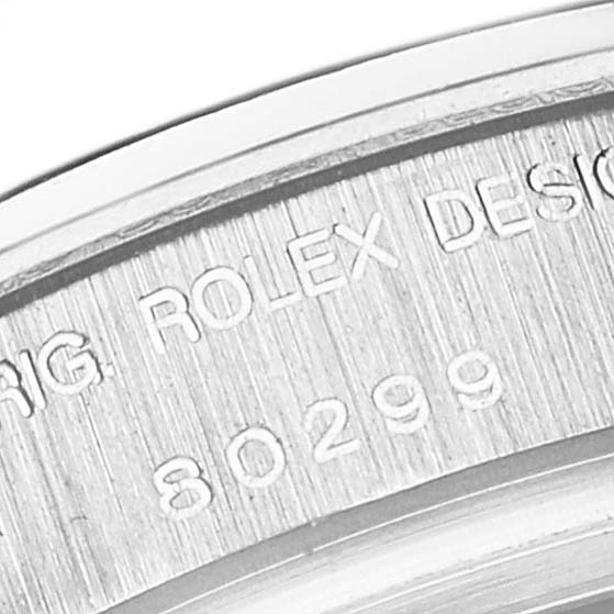 The image shows a close-up view of the Rolex Pearlmaster 80299 Women's White Gold Blue Dial 80299 Women's White Gold Blue Dial's engraved serial number and design information on its inner bezel.