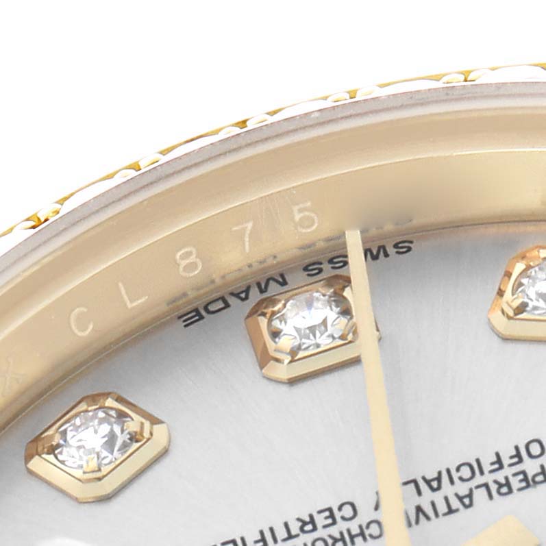 This image shows a close-up of a Rolex President 179158 Women
s Yellow Gold Silver Dial watch, featuring a partial view of the dial, diamond hour markers, and bezel edge.