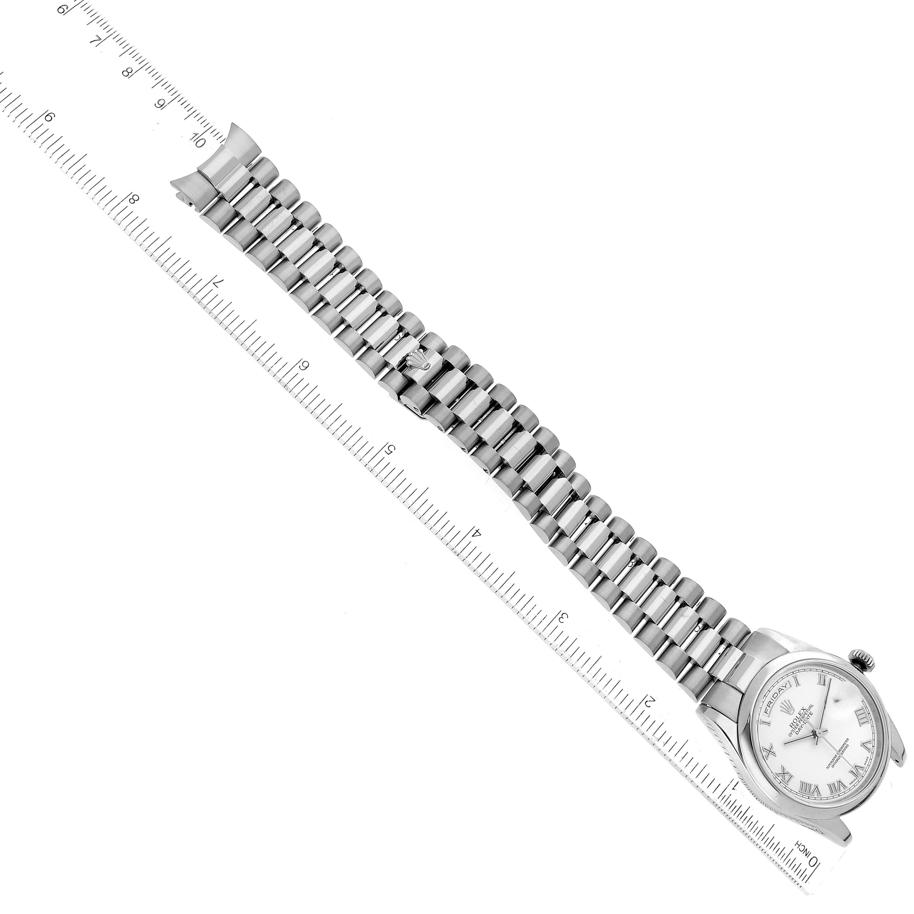 This image shows a Rolex President 118209 Men's White Gold White Dial 118209 Men's White Gold White Dial model watch laid flat next to a ruler, displaying the full bracelet and watch face.