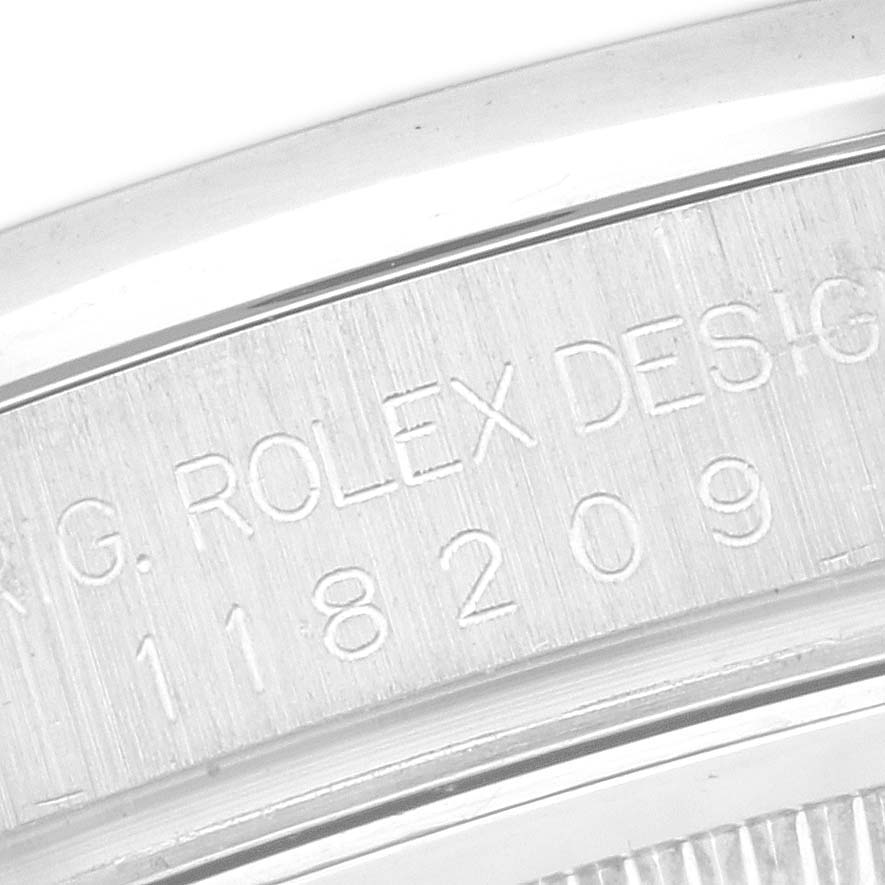 This is a close-up of the case back of a Rolex President 118209 Men's White Gold White Dial 118209 Men's White Gold White Dial watch, showing the engraved model and serial number.