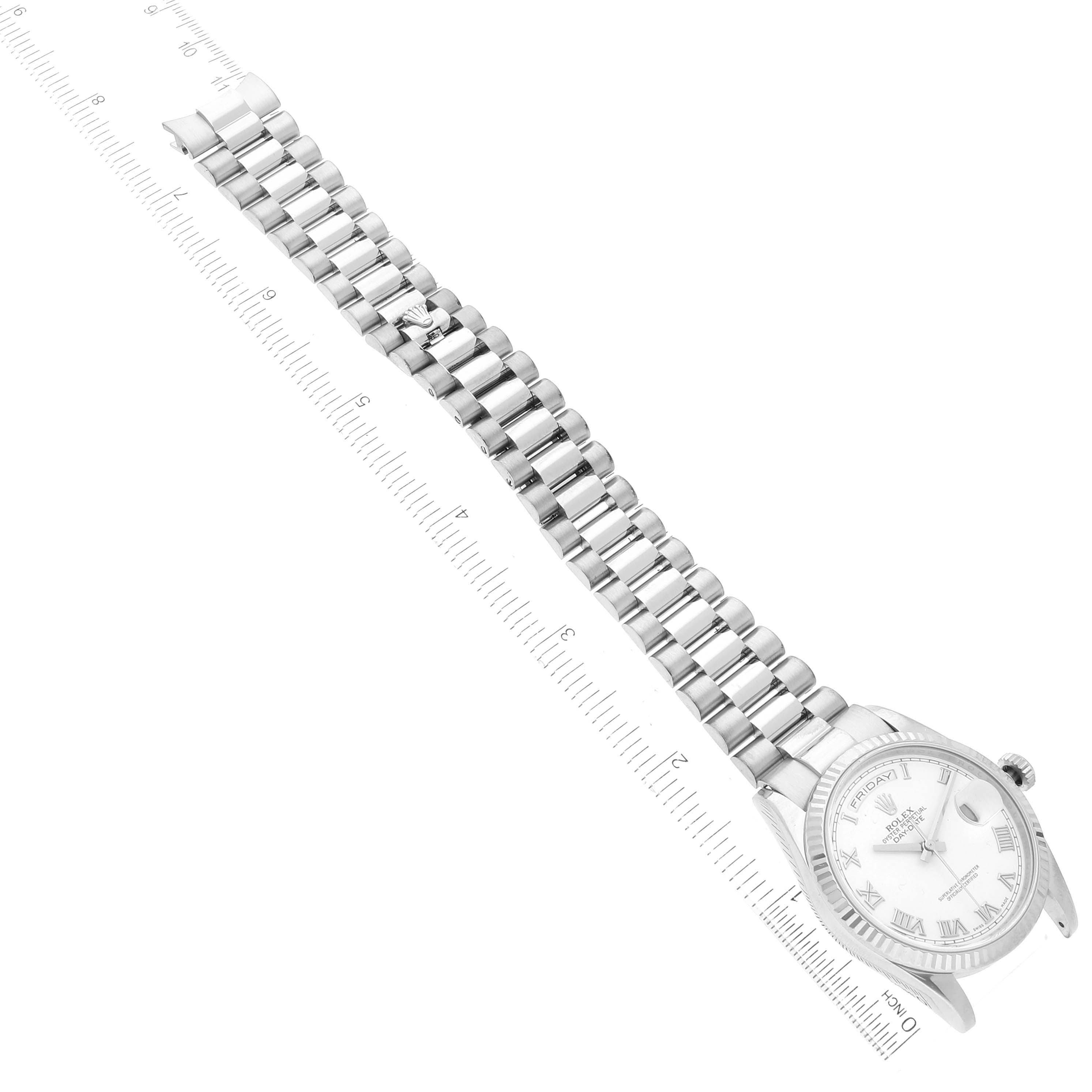The image shows a Rolex President 118239 Men's White Gold White Dial 118239 Men's White Gold White Dial model watch laid flat, showcasing its face and bracelet, alongside a measuring scale.