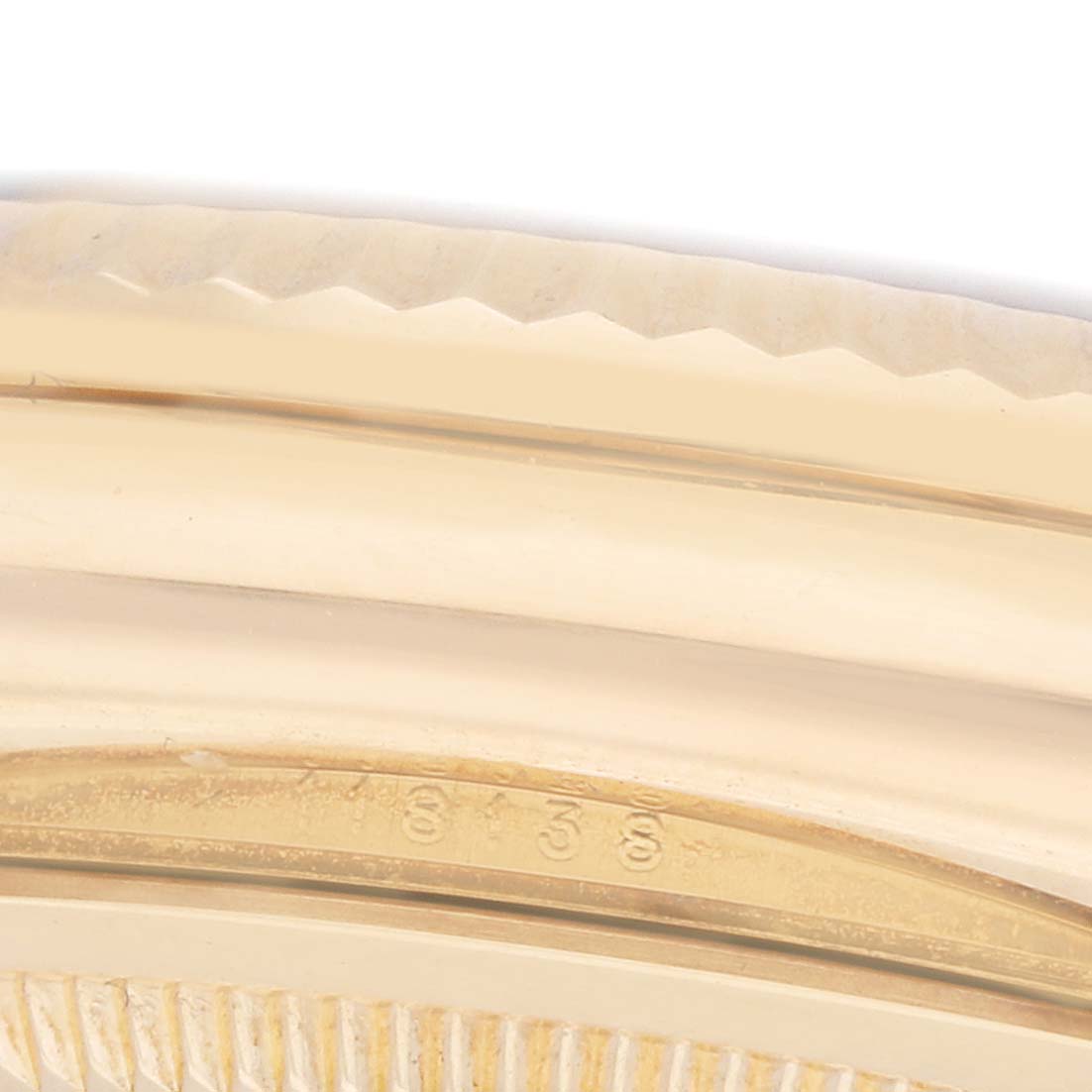 The image shows a close-up of the side of a Rolex President 118139 Men
s Yellow Gold Orange Dial model watch
s bezel and part of the case.