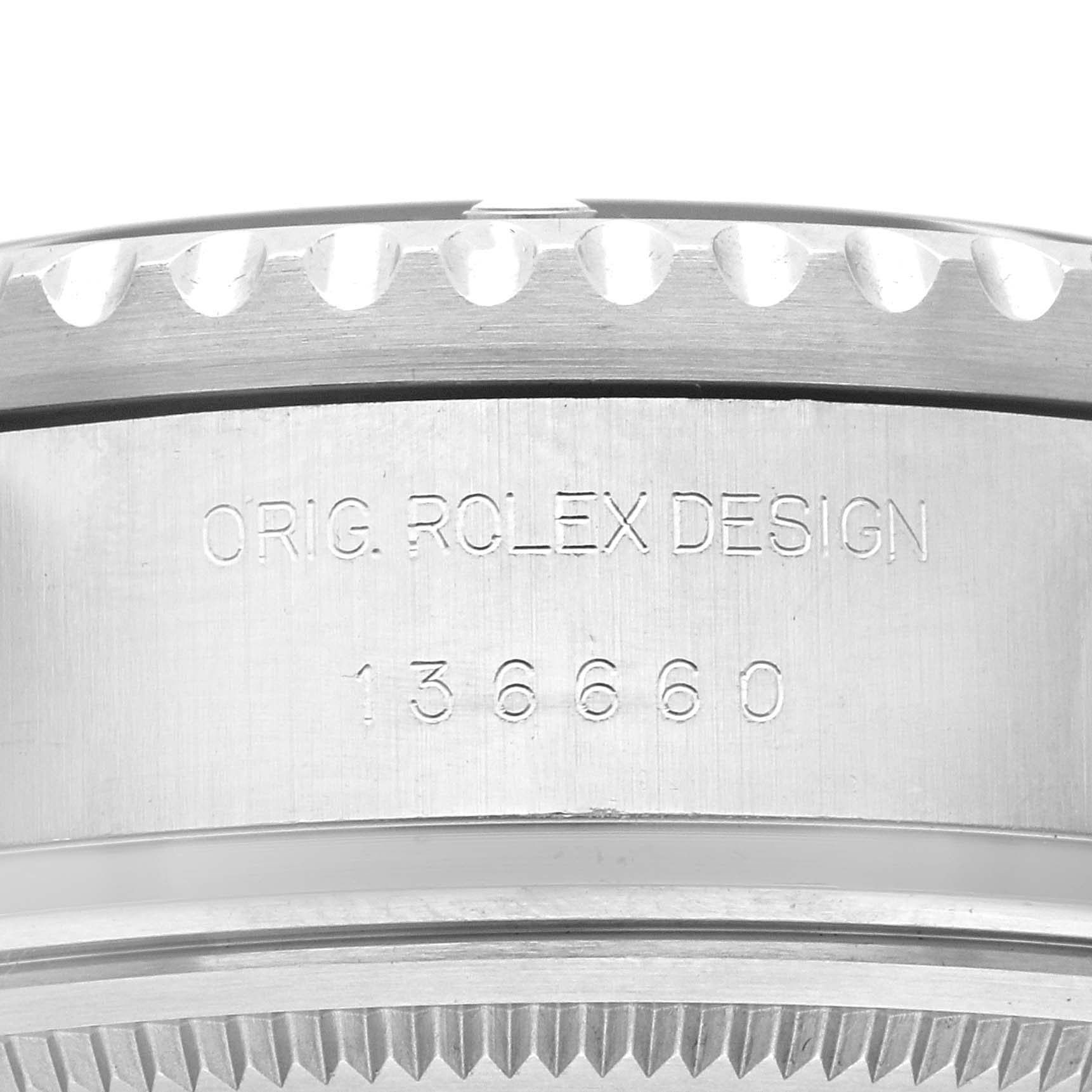 The image shows a close-up side view of the engraved case edge and bezel of a Rolex Sea-Dweller 136660 Men
s Stainless Steel Black Dial watch.