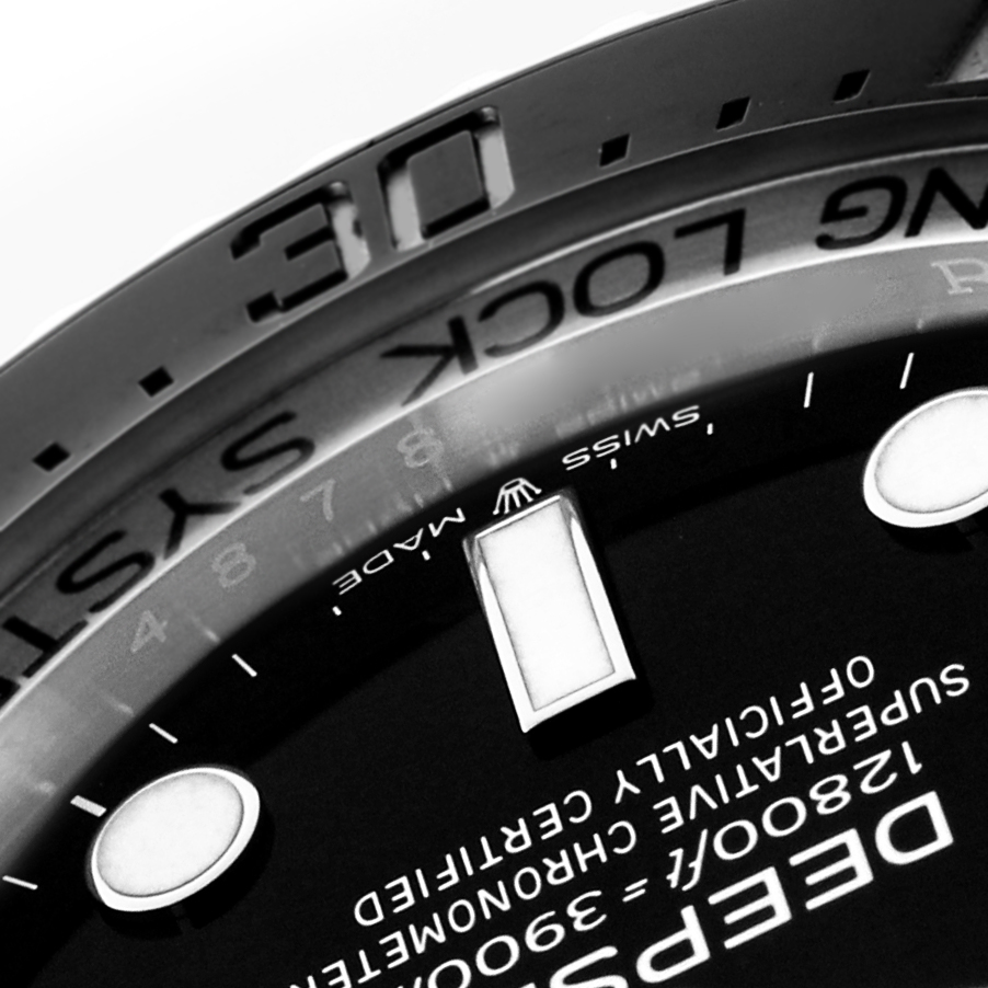 The image shows a close-up of the Rolex Sea-Dweller 136660 Men
s Stainless Steel Black Dial
s dial and bezel from an angled perspective, highlighting details and markings.