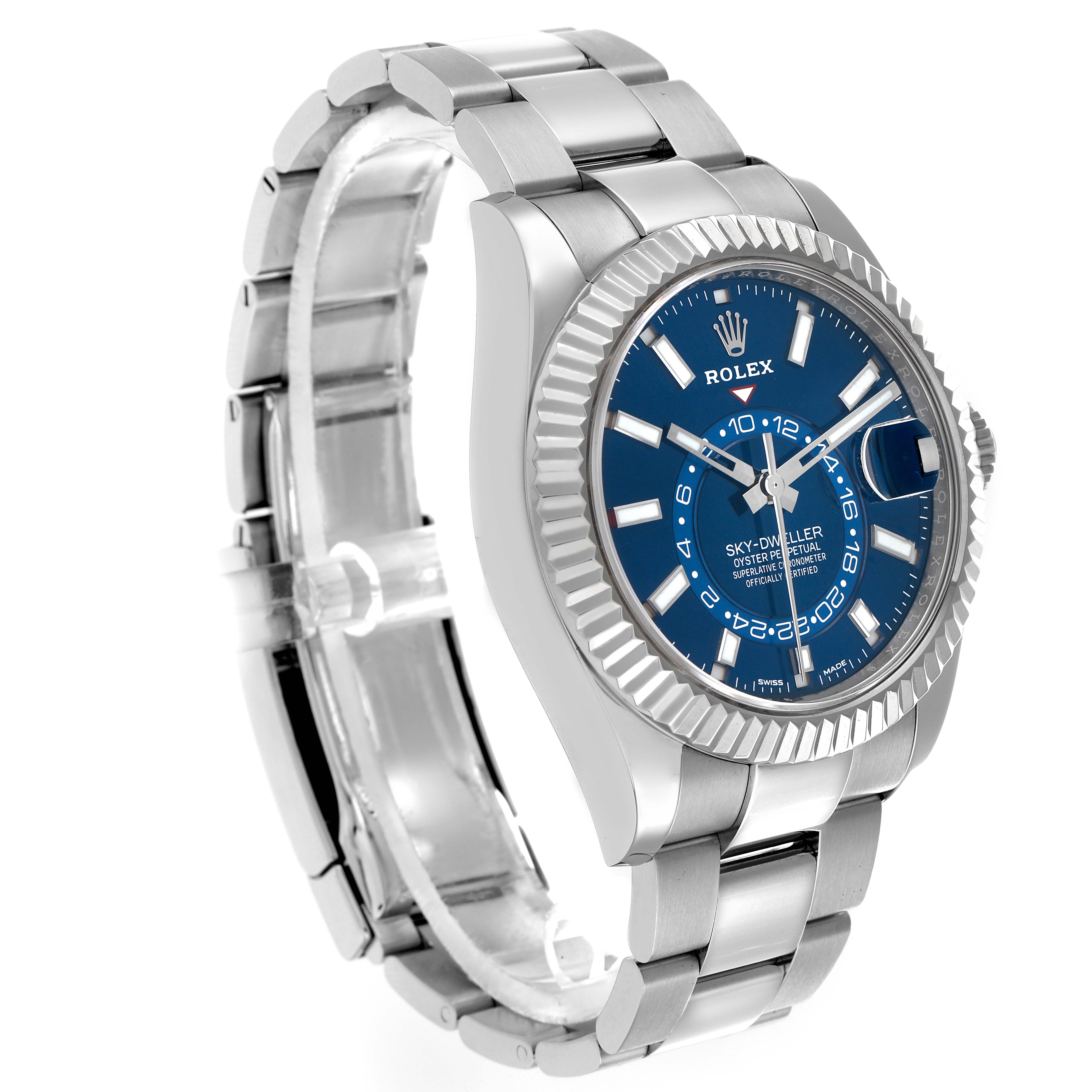 The image shows a Rolex Sky-Dweller 326934 Men
s Stainless Steel Blue Dial watch at a three-quarter angle highlighting the blue dial, fluted bezel, and metal bracelet.