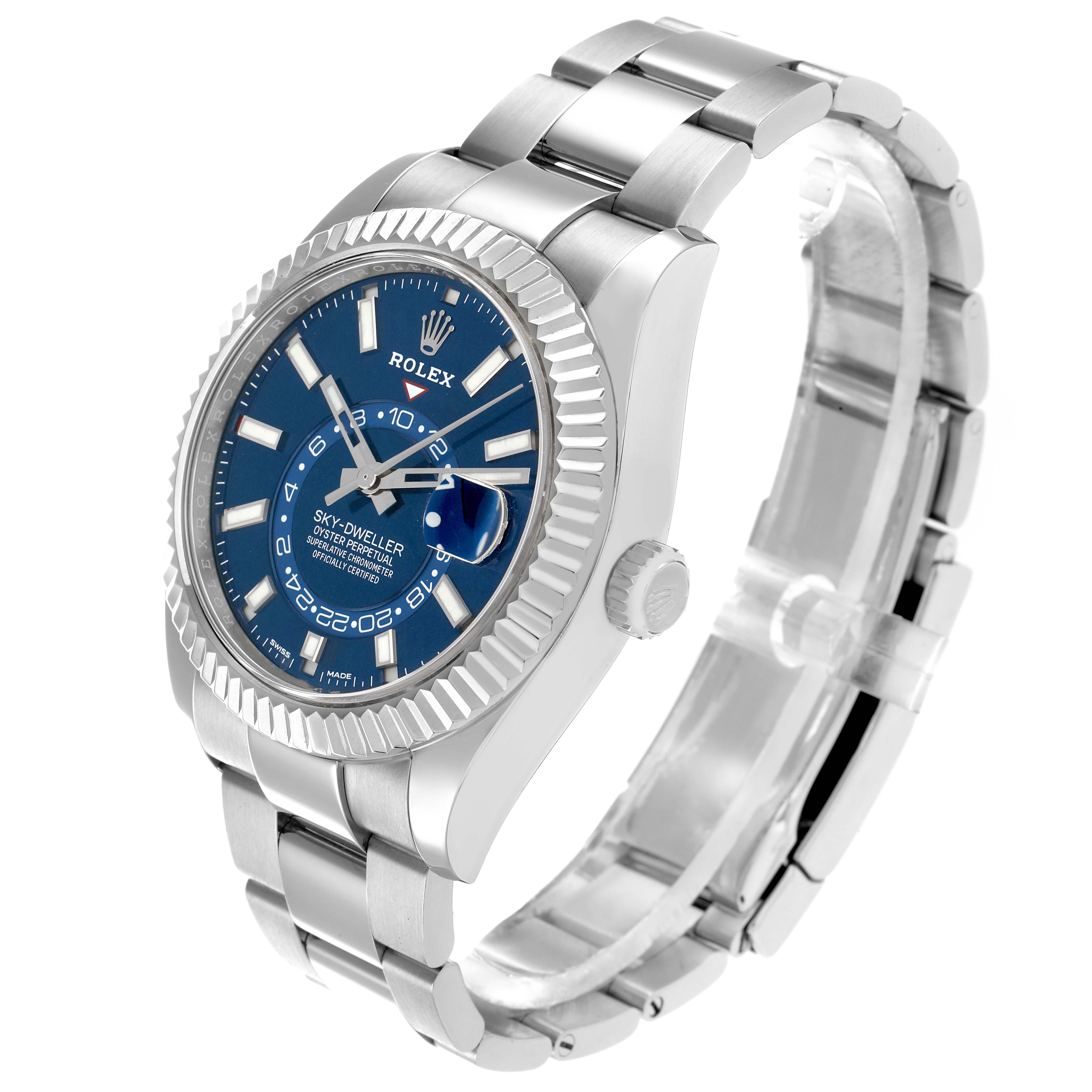 The Rolex Sky-Dweller 326934 Men
s Stainless Steel Blue Dial watch is shown at a three-quarter angle, highlighting its blue dial, bezel, bracelet, and crown.