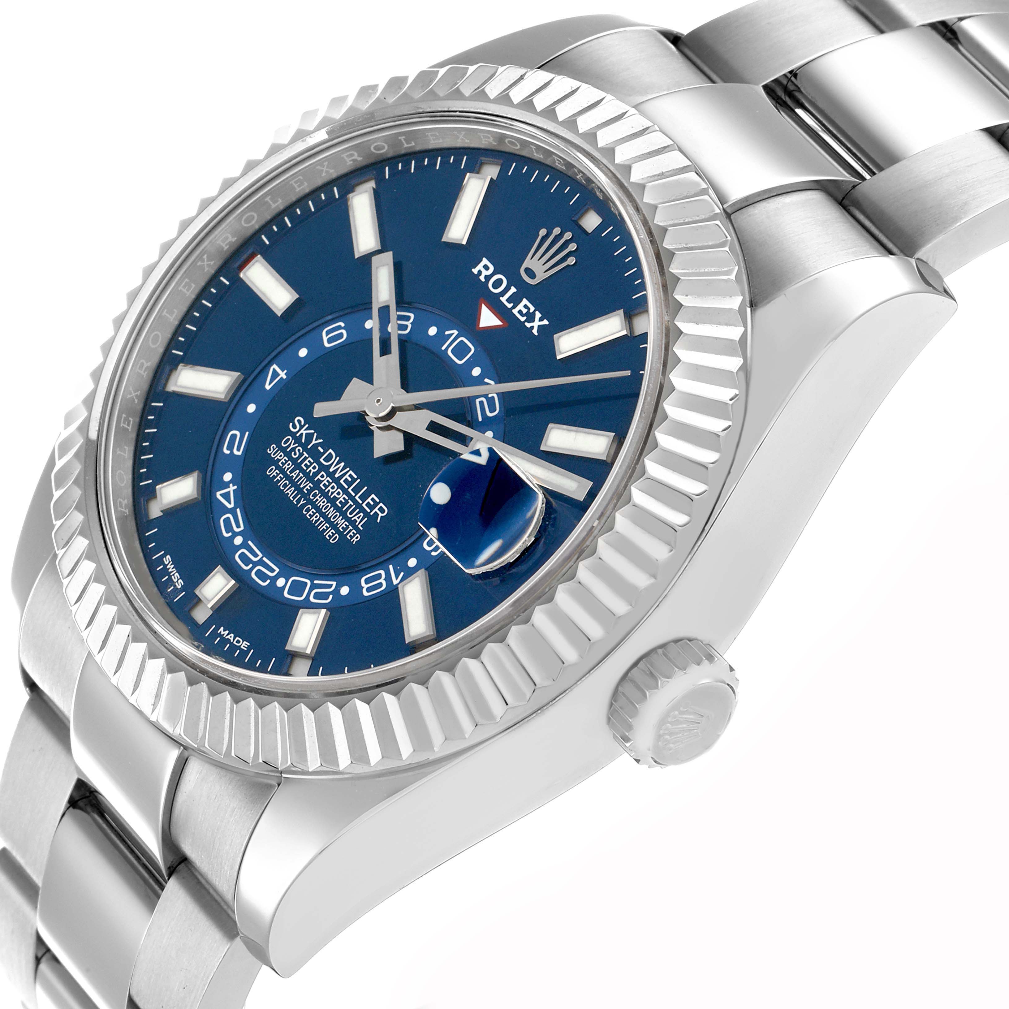 The Rolex Sky-Dweller 326934 Men
s Stainless Steel Blue Dial is shown from an angled side view, highlighting the blue dial, fluted bezel, and part of the bracelet.