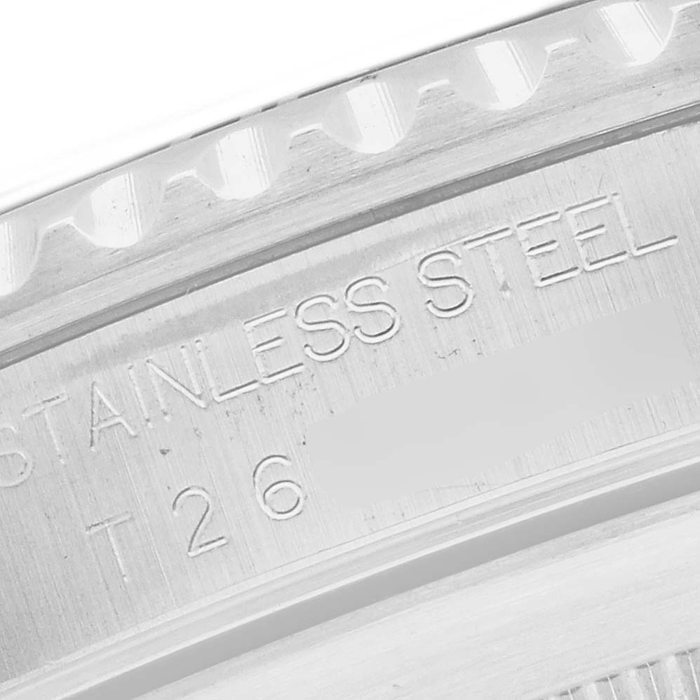 The image shows a close-up view of the stainless steel case of a Rolex Submariner 14060 Men
s Stainless Steel Black Dial, focusing on engraved details.